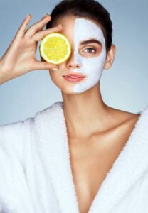 A girl half wearing a mask and half covered with lemon